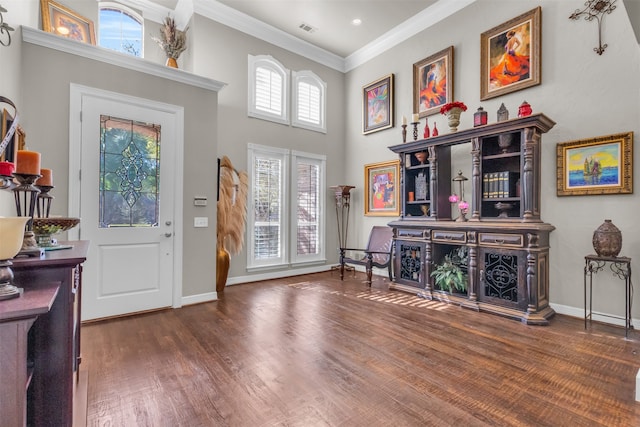 foyer entrance with a towering ceiling, crown molding, and dark wood-type flooring