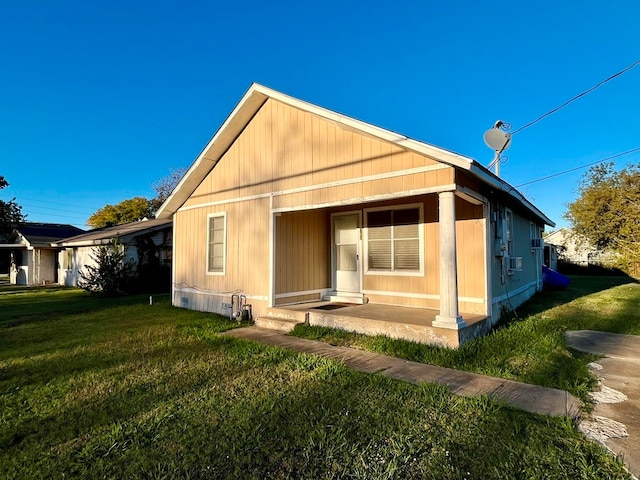 back of property featuring a lawn