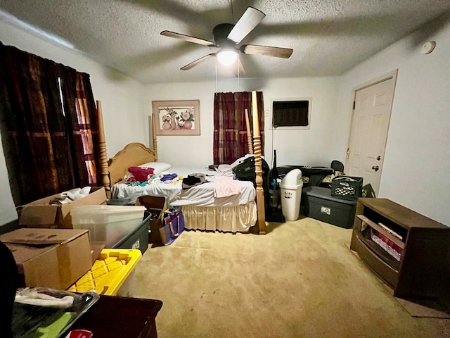 bedroom with ceiling fan, carpet floors, and a textured ceiling