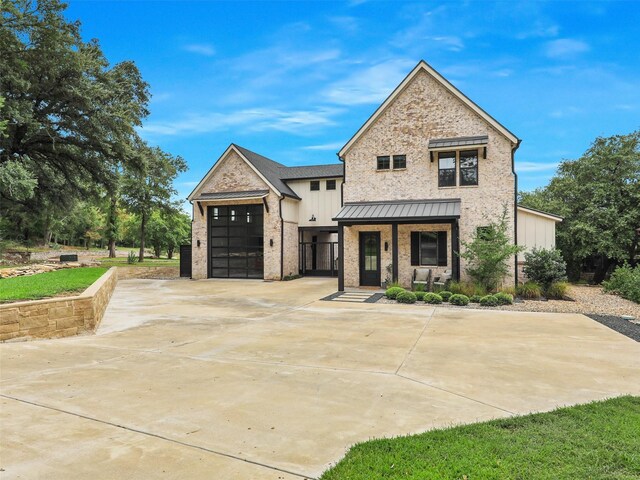 view of front of house featuring a porch and a garage