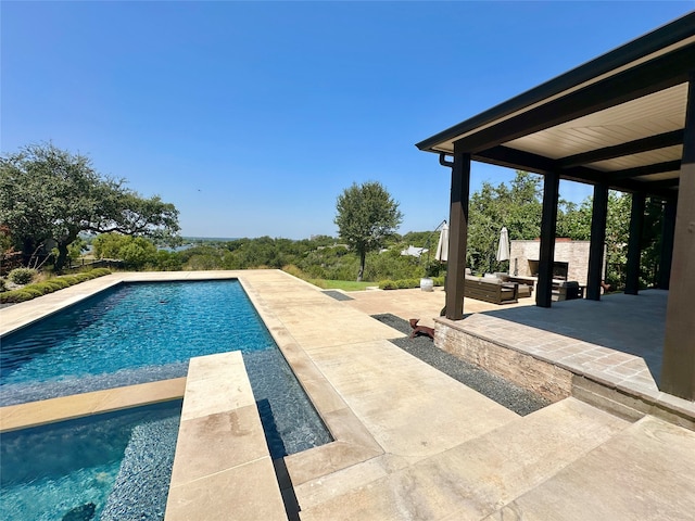 view of swimming pool featuring a patio area