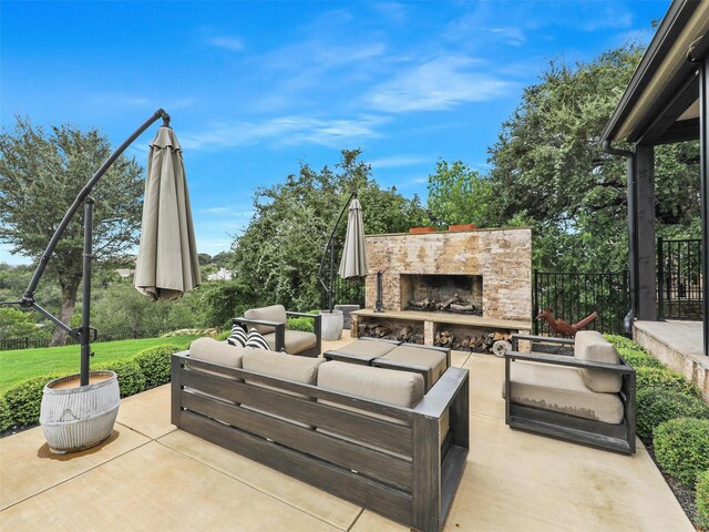 view of patio featuring an outdoor living space with a fireplace