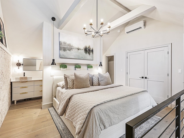 bedroom with an AC wall unit, a closet, light hardwood / wood-style flooring, and high vaulted ceiling