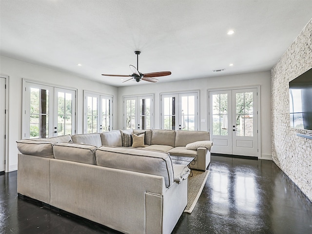 living room with french doors, ceiling fan, and a healthy amount of sunlight