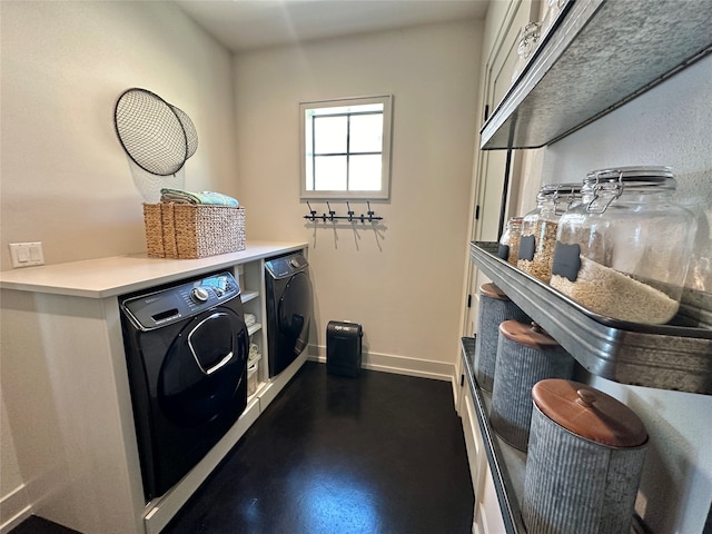 clothes washing area with washing machine and clothes dryer