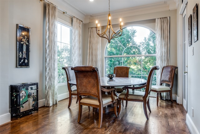 dining space with dark hardwood / wood-style flooring, a wealth of natural light, and a chandelier