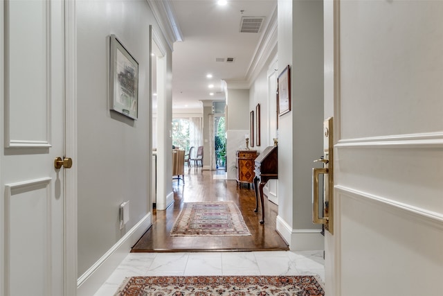 corridor featuring light hardwood / wood-style flooring and crown molding