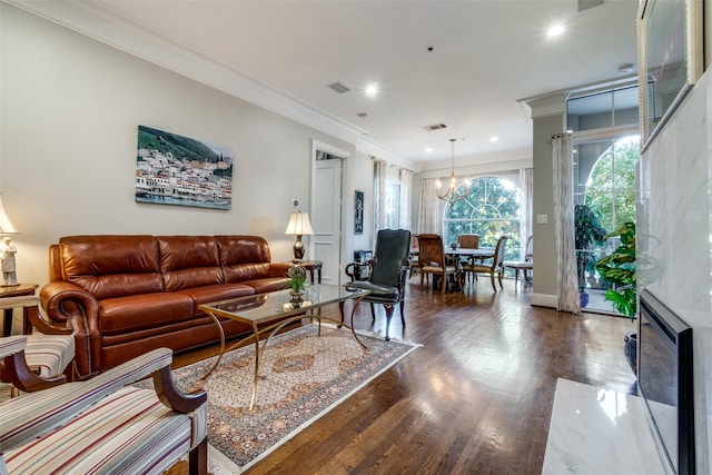 living room featuring a chandelier, crown molding, and dark wood-type flooring