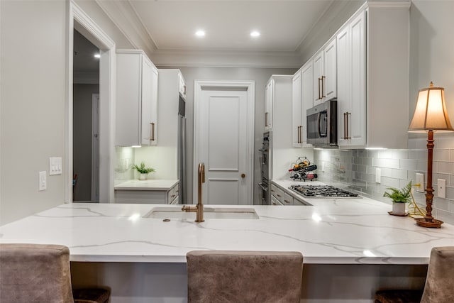 kitchen with a kitchen bar, kitchen peninsula, and stainless steel appliances