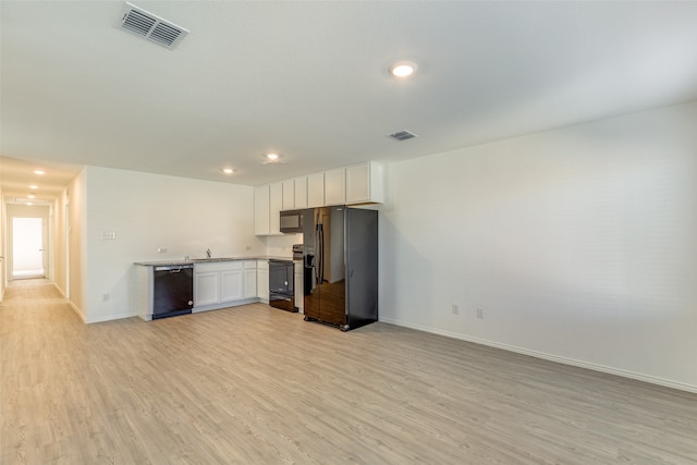 kitchen featuring white cabinetry, light hardwood / wood-style flooring, black appliances, and sink