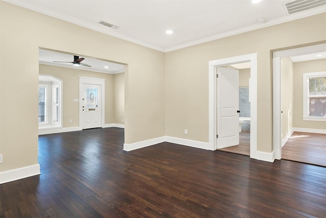 spare room featuring crown molding, dark hardwood / wood-style floors, and ceiling fan