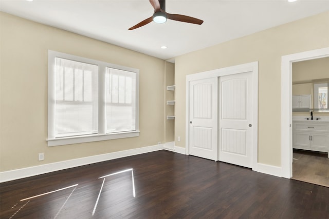 unfurnished bedroom featuring ceiling fan, dark hardwood / wood-style floors, and a closet