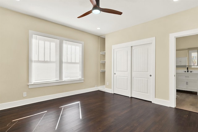 unfurnished bedroom with dark hardwood / wood-style floors, ceiling fan, and a closet