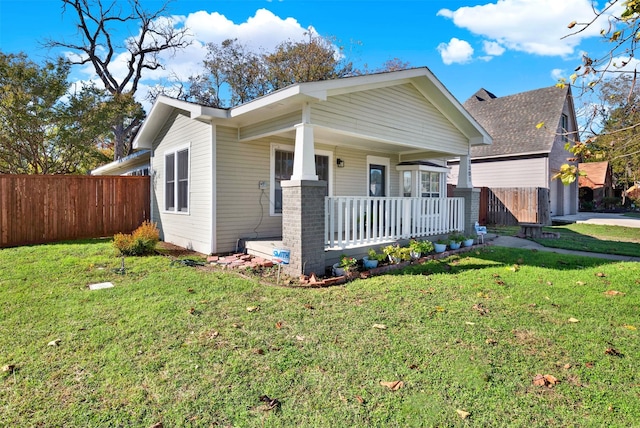 view of front of house featuring a front lawn and covered porch