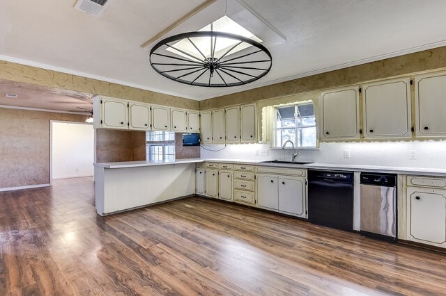 kitchen with crown molding, dishwasher, dark wood-type flooring, and sink