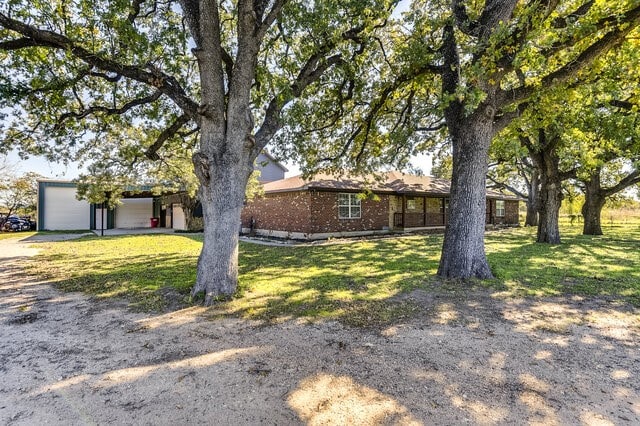 single story home featuring a front yard and a garage