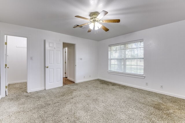 carpeted empty room with ceiling fan