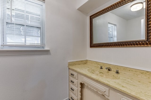 bathroom with vanity and a wealth of natural light