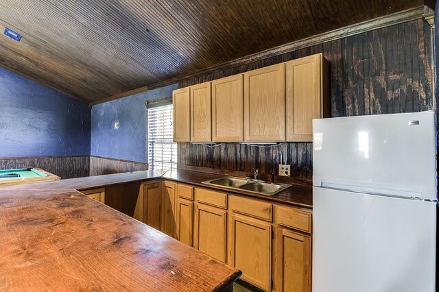 kitchen with sink, wood counters, white fridge, vaulted ceiling, and wood ceiling