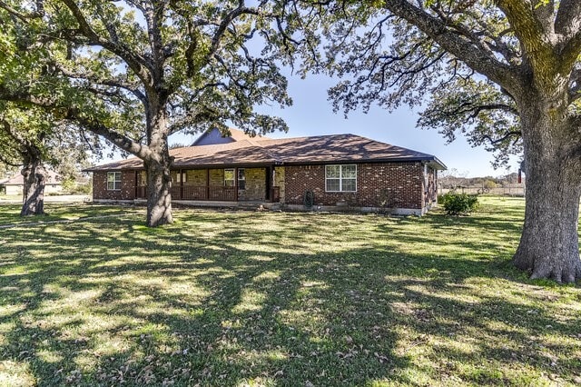 ranch-style home with a front lawn