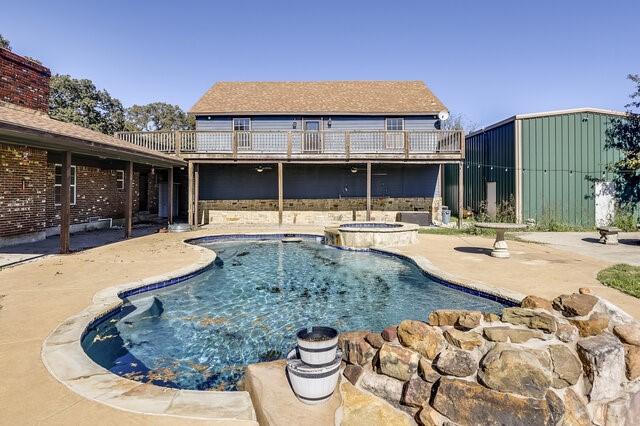 view of pool with a patio area and an in ground hot tub