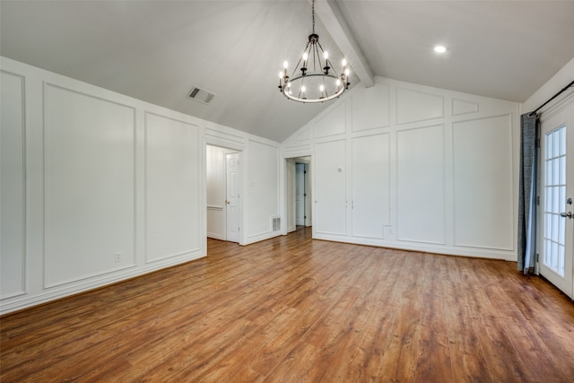 interior space with a chandelier, vaulted ceiling with beams, light hardwood / wood-style floors, and a healthy amount of sunlight