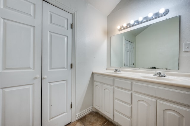 bathroom with vanity, tile patterned floors, and lofted ceiling