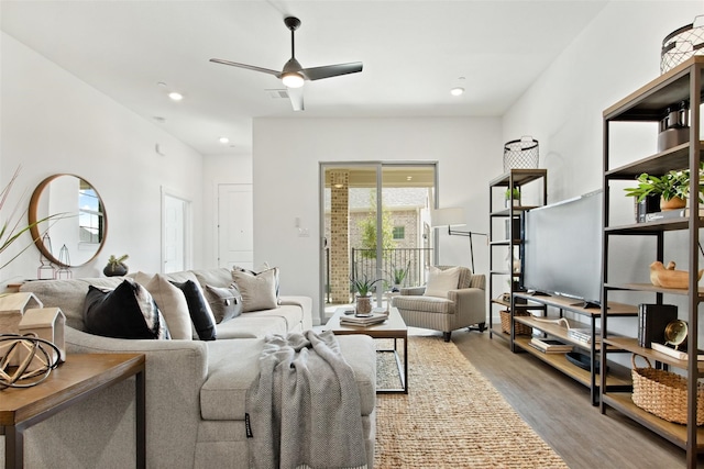 living room featuring ceiling fan and hardwood / wood-style floors