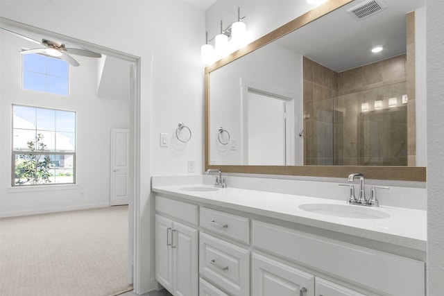 bathroom with a ceiling fan, visible vents, a sink, and a shower stall