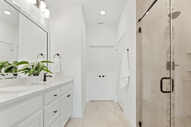 bathroom featuring vanity and a shower with shower door