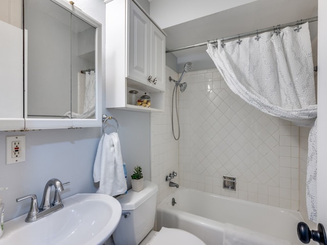 full bathroom featuring shower / bath combination with curtain, toilet, and sink