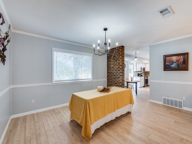 dining room with a chandelier, light hardwood / wood-style floors, and crown molding