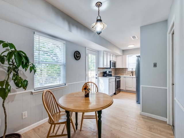 dining room with light wood-type flooring