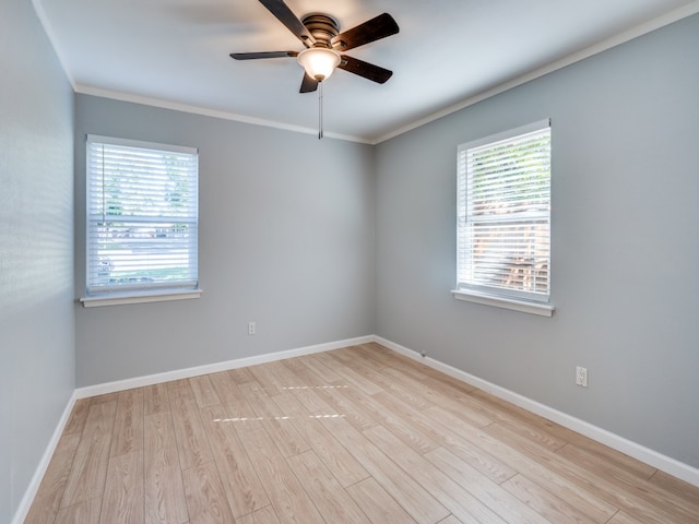 empty room featuring ceiling fan, light hardwood / wood-style floors, and ornamental molding