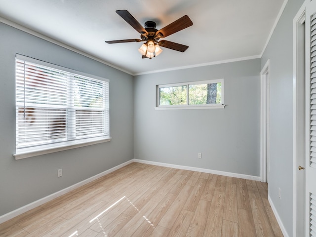 empty room featuring ceiling fan, light hardwood / wood-style flooring, and ornamental molding