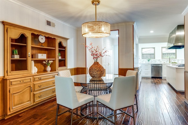 dining area with a notable chandelier, dark hardwood / wood-style floors, and crown molding