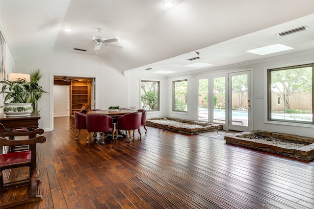 living room featuring ceiling fan, dark hardwood / wood-style flooring, vaulted ceiling, and ornamental molding