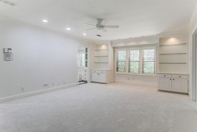 unfurnished bedroom featuring ceiling fan, light colored carpet, and ornamental molding