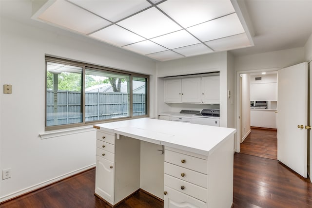 unfurnished office featuring washing machine and dryer and dark wood-type flooring