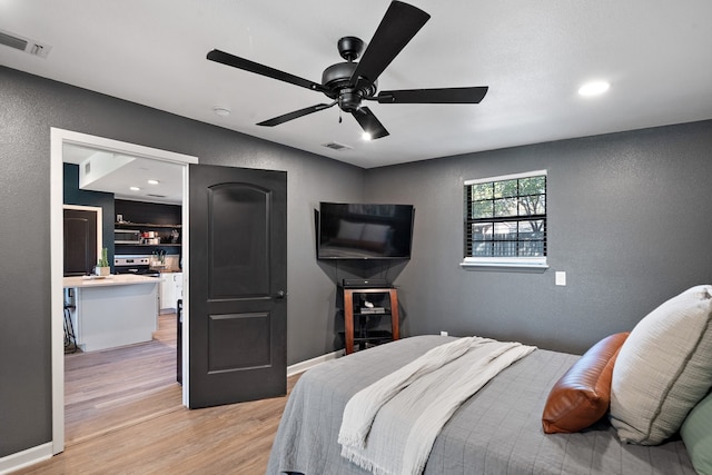 bedroom featuring ceiling fan and light hardwood / wood-style flooring