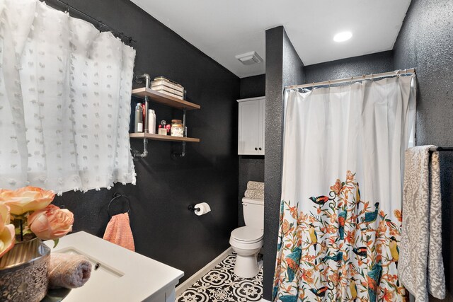 bathroom featuring tile patterned floors, a shower with shower curtain, and toilet