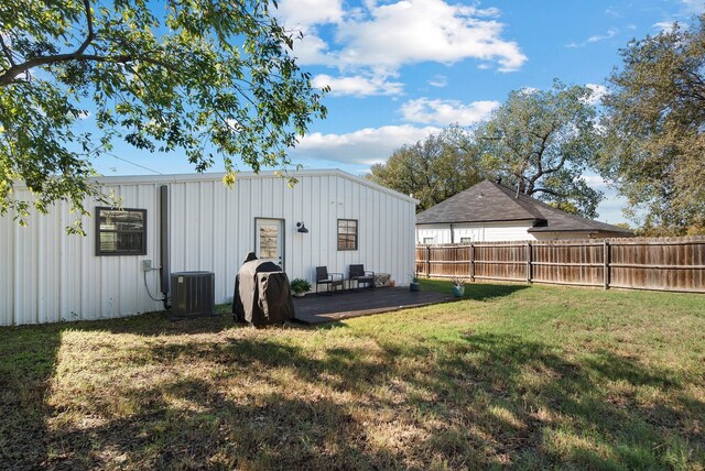 view of yard with a deck and central AC unit