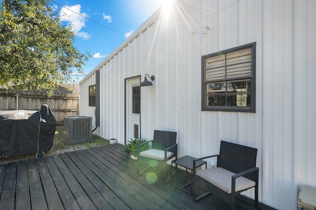 wooden deck with a grill and central air condition unit