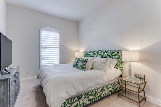 bedroom featuring light colored carpet