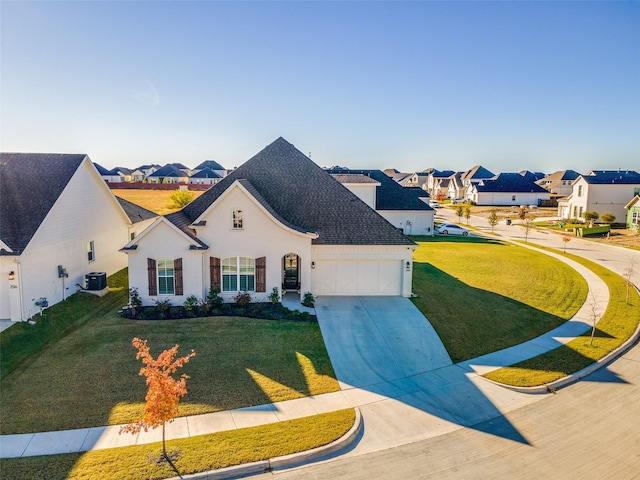 view of front of house featuring a garage, a front yard, and central AC