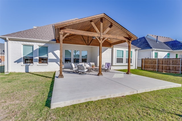 back of house with an outdoor hangout area, a yard, and a patio