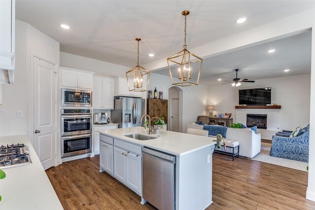 kitchen with white cabinetry, sink, a kitchen island with sink, and appliances with stainless steel finishes