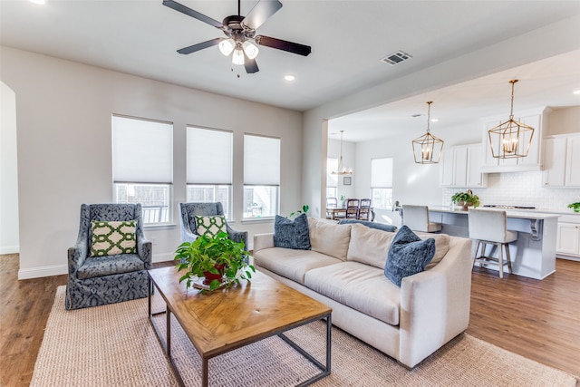 living room with light hardwood / wood-style flooring and ceiling fan