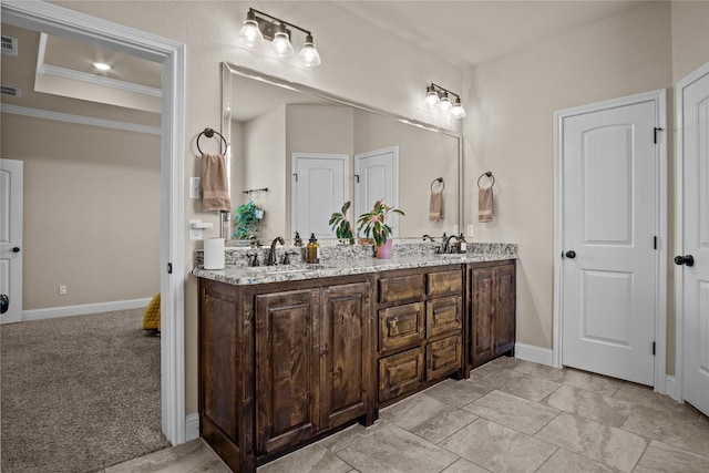 bathroom featuring crown molding and vanity