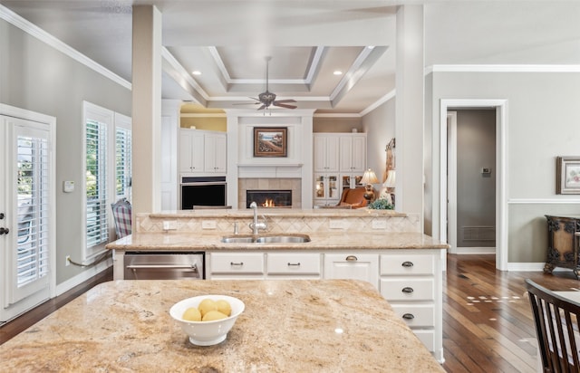 kitchen featuring white cabinets, sink, dark hardwood / wood-style floors, decorative backsplash, and light stone countertops